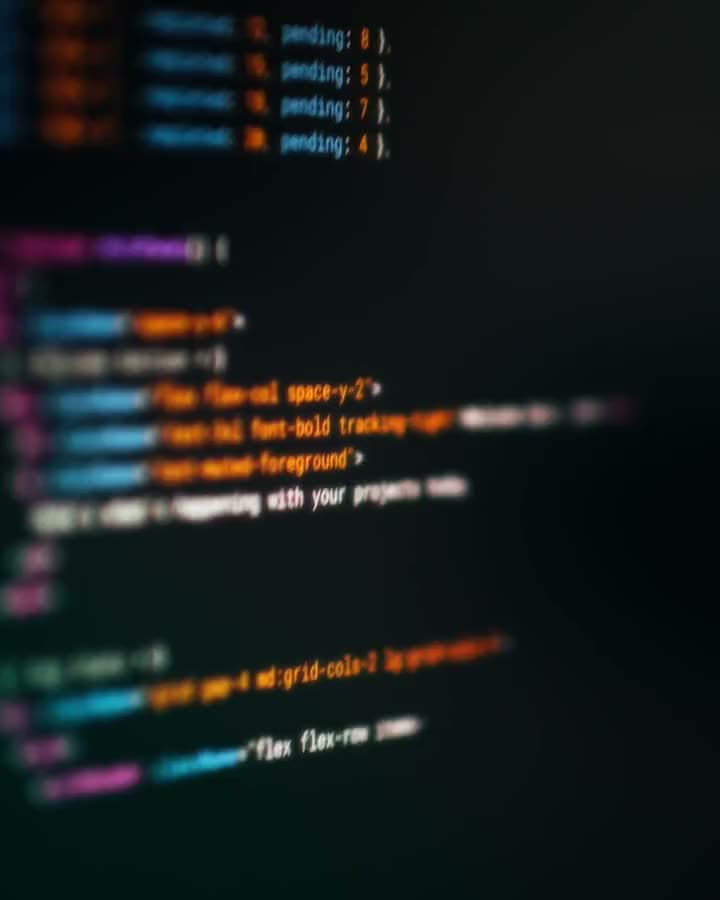 Lines of colour-highlighted code drifting across a dark screen.